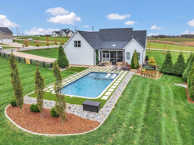 back of property featuring a fenced backyard, a yard, a sunroom, an outdoor pool, and a patio area