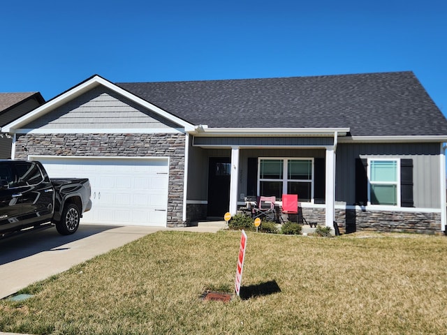 view of front of home with roof with shingles, an attached garage, concrete driveway, a front lawn, and stone siding