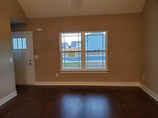 entrance foyer with baseboards, dark wood finished floors, and vaulted ceiling