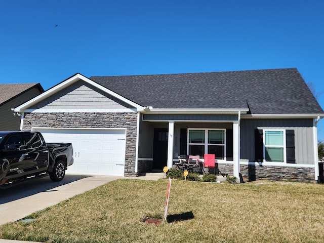 view of front facade with a front lawn, concrete driveway, roof with shingles, stone siding, and an attached garage