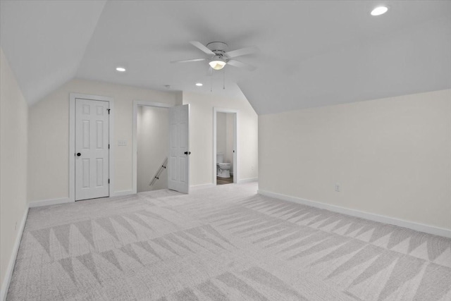 additional living space with recessed lighting, baseboards, lofted ceiling, and light carpet