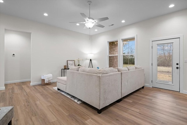 living area with recessed lighting, visible vents, baseboards, and light wood-style flooring