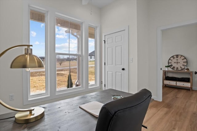 sitting room featuring light wood-type flooring and baseboards