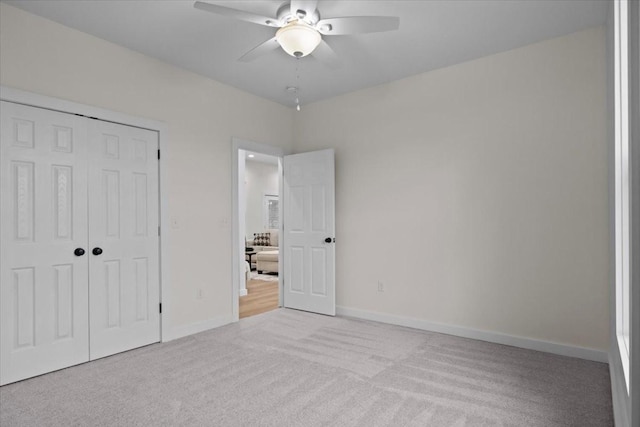 unfurnished bedroom with a ceiling fan, carpet flooring, baseboards, and a closet