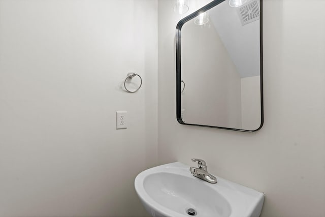 bathroom featuring visible vents and a sink