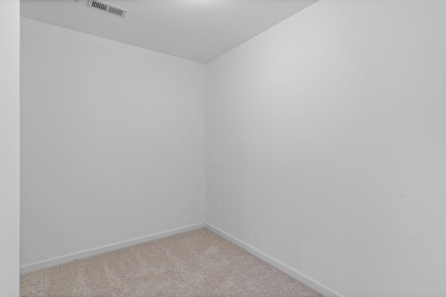 spare room with visible vents, baseboards, and carpet flooring