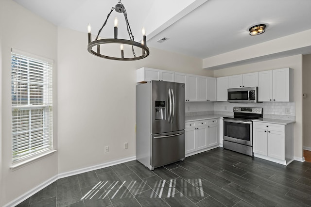 kitchen featuring visible vents, backsplash, appliances with stainless steel finishes, white cabinets, and light countertops