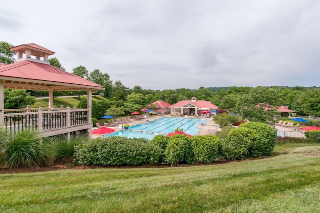 pool featuring a gazebo, a yard, a patio, and fence