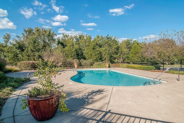 view of pool with a patio area, a fenced in pool, and fence