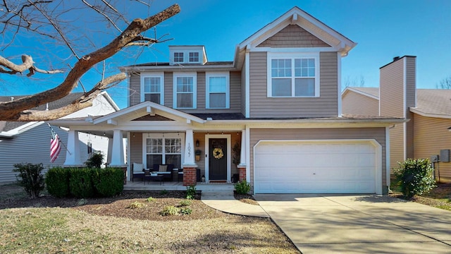 craftsman-style home featuring a porch, concrete driveway, and a garage