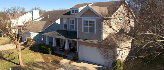 view of front facade with a front yard, an attached garage, and driveway