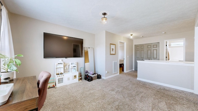 office featuring visible vents, baseboards, carpet floors, and a textured ceiling