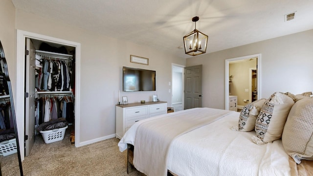 bedroom with visible vents, baseboards, a chandelier, light carpet, and a closet