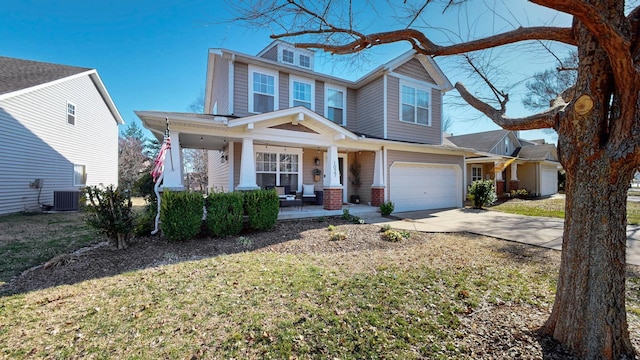 view of front of property with concrete driveway, a garage, covered porch, and a front lawn