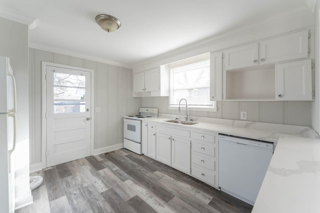 kitchen featuring white cabinets, white appliances, crown molding, and a sink