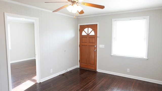 entryway featuring dark wood finished floors, a ceiling fan, crown molding, and baseboards