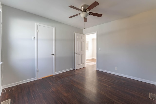 unfurnished bedroom with visible vents, a ceiling fan, baseboards, and wood finished floors