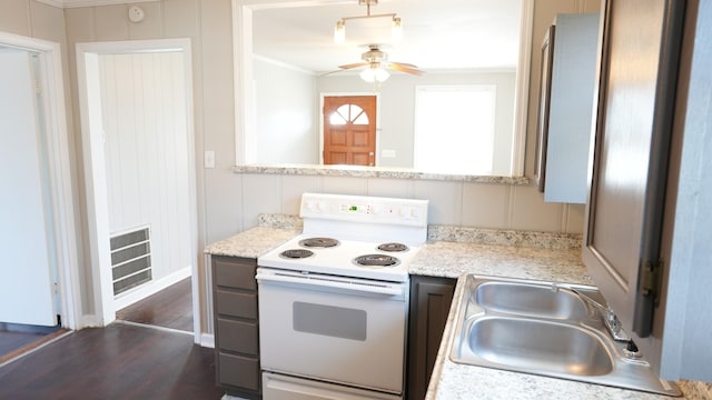 kitchen featuring a ceiling fan, visible vents, a sink, light countertops, and electric stove