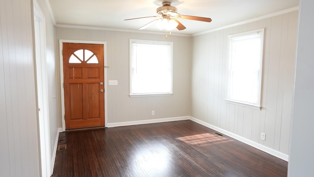 foyer entrance featuring a wealth of natural light, crown molding, dark wood-type flooring, and baseboards