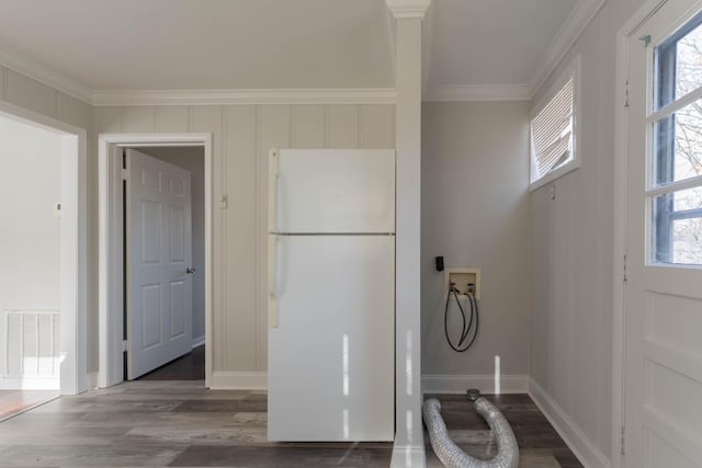 interior space featuring crown molding, wood finished floors, visible vents, and baseboards