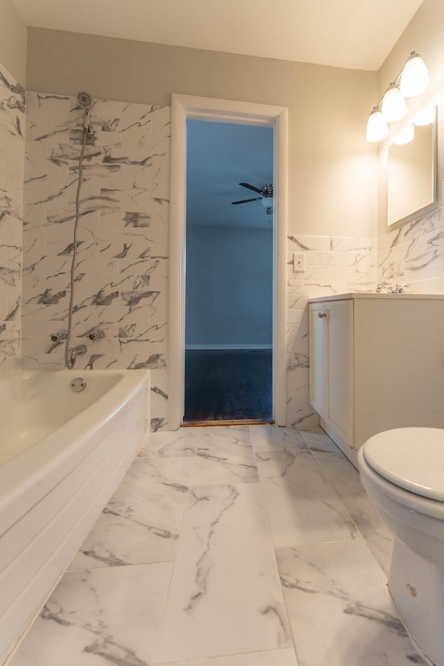 bathroom featuring vanity, toilet, tub / shower combination, and marble finish floor