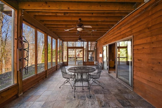 sunroom / solarium featuring french doors, outdoor dining area, and ceiling fan