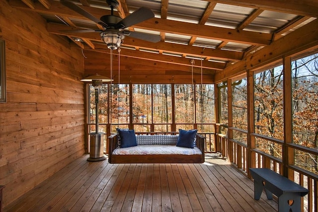 sunroom / solarium with beamed ceiling and ceiling fan