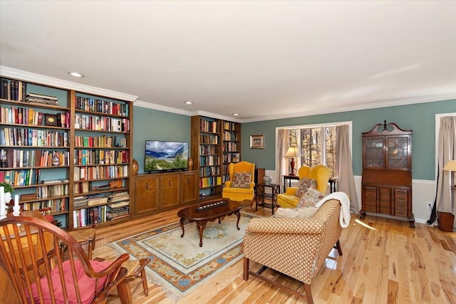 sitting room featuring crown molding, recessed lighting, built in shelves, and wood finished floors