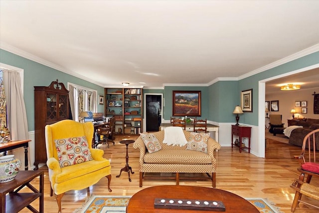 living room with ornamental molding and wood finished floors