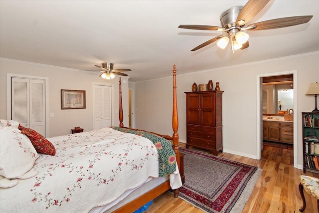 bedroom featuring crown molding, a ceiling fan, two closets, and light wood-style floors