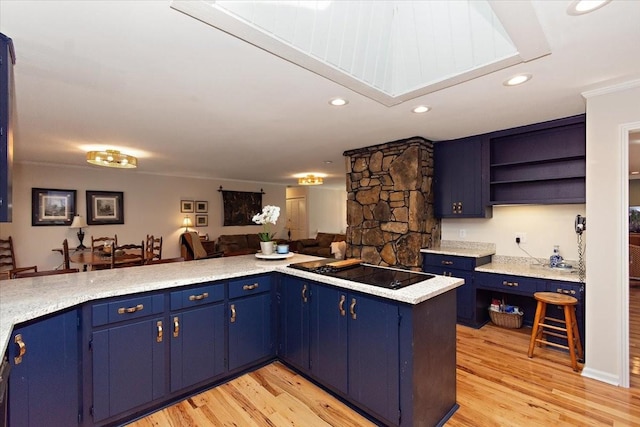 kitchen with light countertops, blue cabinetry, black electric stovetop, and light wood-type flooring