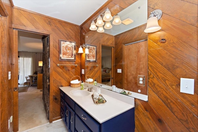 bathroom featuring vanity and wooden walls