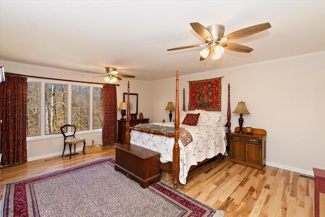 bedroom with light wood-type flooring, ornamental molding, baseboards, and ceiling fan