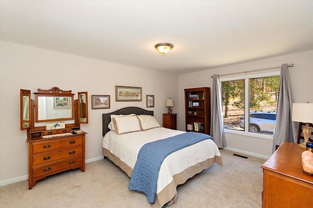 bedroom featuring light colored carpet, baseboards, and visible vents