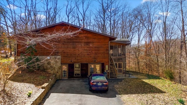 view of home's exterior with french doors and stairway