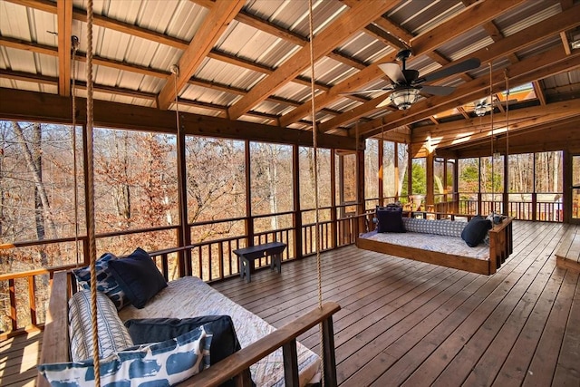 unfurnished sunroom with ceiling fan