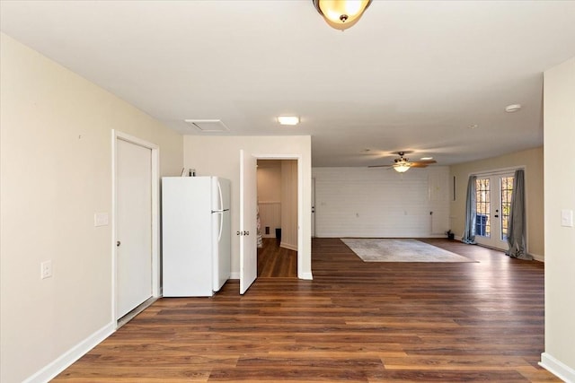 interior space with ceiling fan, french doors, baseboards, visible vents, and dark wood-style floors