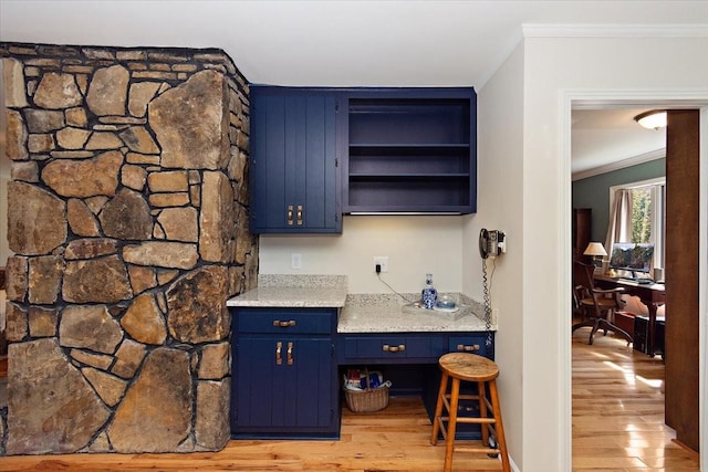 bar featuring crown molding and light wood-style flooring