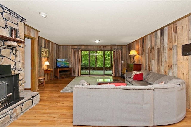 living area featuring crown molding, wood finished floors, and wooden walls