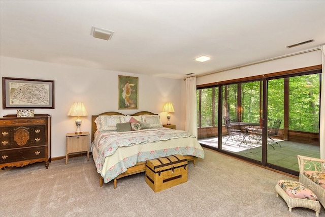 bedroom with visible vents, carpet, and access to exterior