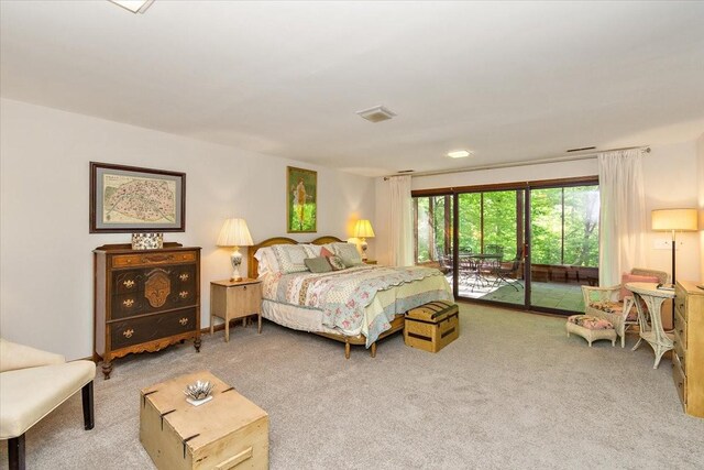 bedroom with carpet floors, visible vents, and access to exterior