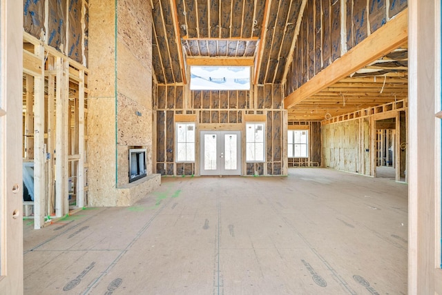 unfurnished living room featuring a high ceiling