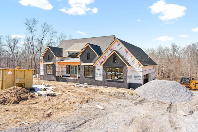 property in mid-construction featuring brick siding, driveway, and an attached garage