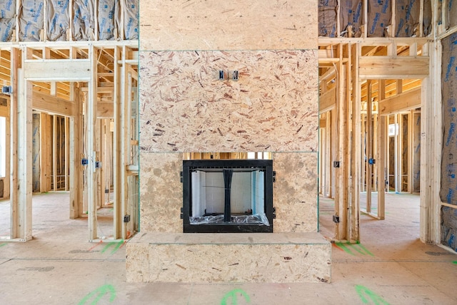 misc room with a fireplace with raised hearth