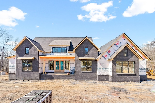 view of front facade featuring french doors and brick siding