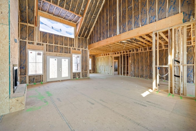 misc room featuring french doors and a towering ceiling