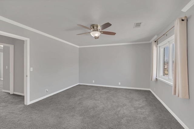 empty room featuring visible vents, carpet flooring, crown molding, and baseboards