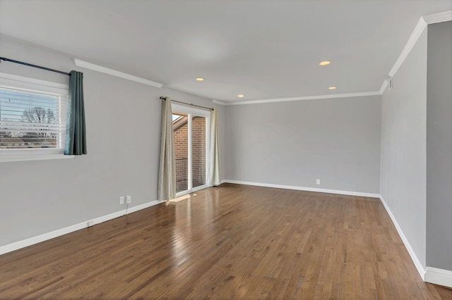 unfurnished room with plenty of natural light, ornamental molding, baseboards, and hardwood / wood-style flooring