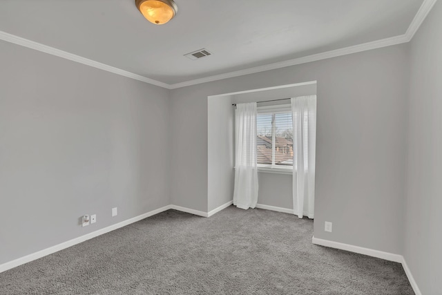 empty room featuring carpet flooring, baseboards, visible vents, and crown molding