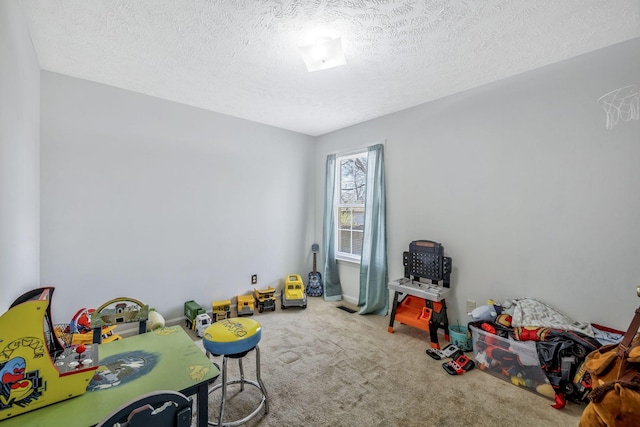 rec room featuring carpet flooring and a textured ceiling